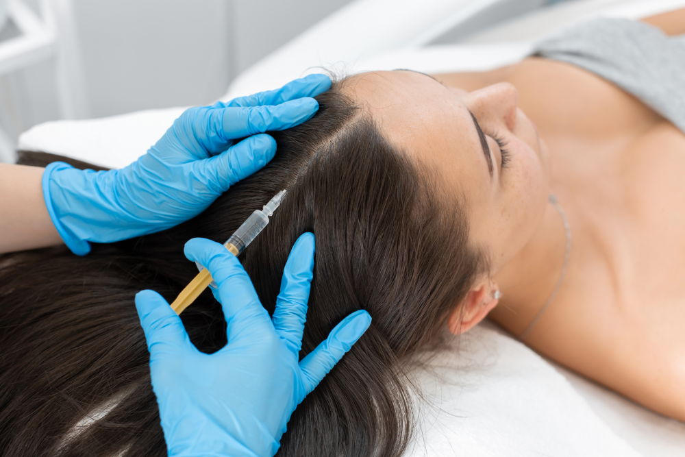 Professional administering Mesotherapy to the scalp.